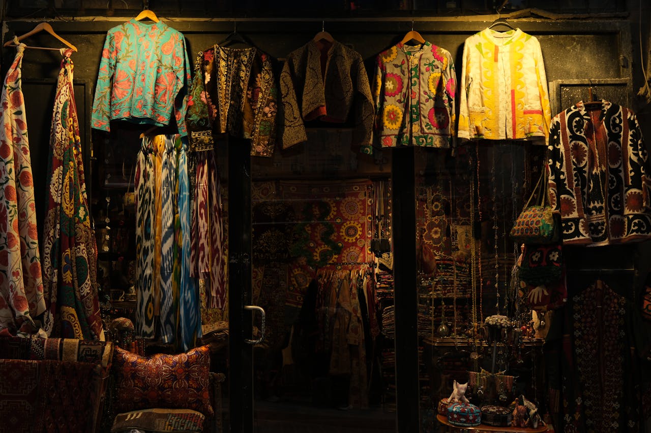 Vibrant display of traditional patterned textiles and garments in a shop.